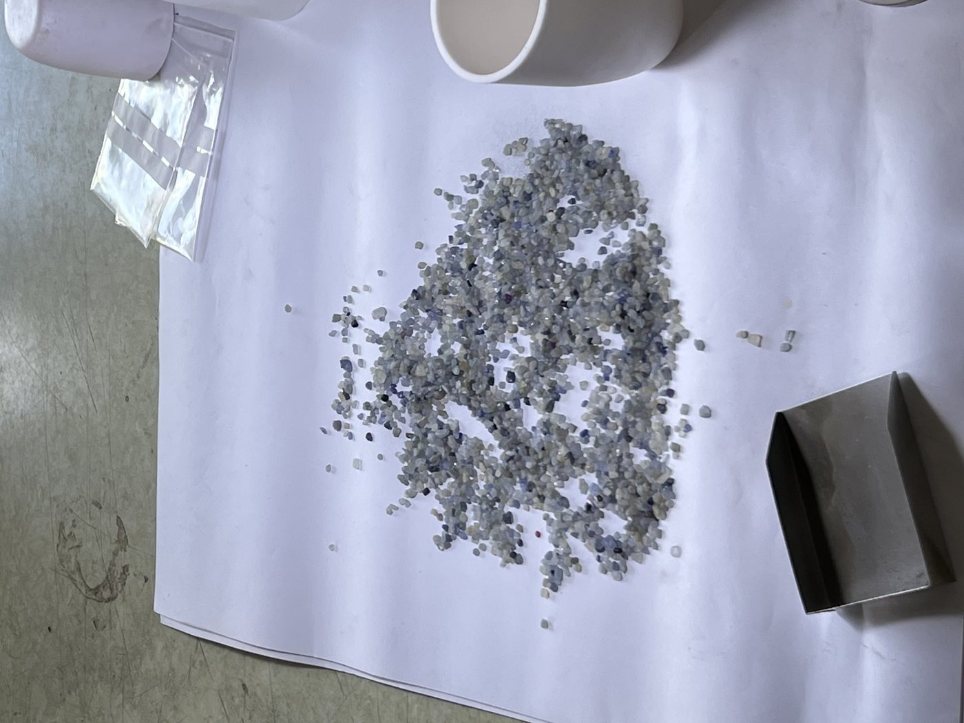 A parcel of rough spread across sorting paper on a dealer's bench